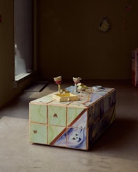 a coffee table in a room with a bottle of wine on it